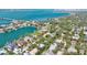 Aerial view of neighborhood, showcasing the property surrounded by lush greenery near Sarasota Bay and downtown Sarasota at 3705 Tangier Ter, Sarasota, FL 34239