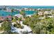 Aerial photo features a sun-drenched home with lush, tropical landscaping and nearby waterways at 3705 Tangier Ter, Sarasota, FL 34239