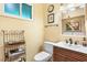 Bathroom with a wooden vanity, sleek faucet, modern toilet, and decorative elements adding character at 3705 Tangier Ter, Sarasota, FL 34239