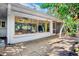 Home exterior showcasing a patio with bird feeders, a glimpse into the interior, and a well-maintained yard at 3705 Tangier Ter, Sarasota, FL 34239