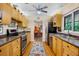 Well-lit kitchen featuring wood cabinetry, modern appliances, and a view into the dining area at 3705 Tangier Ter, Sarasota, FL 34239