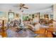 Bright living room featuring hardwood floors, a piano, and an open floor plan at 3705 Tangier Ter, Sarasota, FL 34239