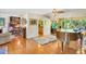 Bright living room featuring hardwood floors, a piano, and natural light at 3705 Tangier Ter, Sarasota, FL 34239