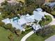 Expansive aerial view of a luxury estate featuring a pool, lush landscaping, and a circular driveway at 3759 Beneva Oaks Blvd, Sarasota, FL 34238