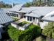 Aerial perspective of the property highlighting architectural details, lush landscaping, and a giant chess set at 3759 Beneva Oaks Blvd, Sarasota, FL 34238