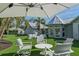 Relaxing backyard seating arrangement under a large umbrella, perfect for outdoor gatherings at 3759 Beneva Oaks Blvd, Sarasota, FL 34238