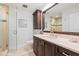 Bathroom featuring wood vanity cabinet, a large mirror, and a glass-enclosed shower with mosaic tile accents at 3759 Beneva Oaks Blvd, Sarasota, FL 34238