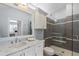 Bathroom with marble vanity, white cabinets, and a glass-enclosed shower featuring tiled walls and built in marble shelf at 3759 Beneva Oaks Blvd, Sarasota, FL 34238