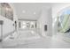 Bright, white bathroom with a soaking tub, walk-in shower, and marble floors at 3759 Beneva Oaks Blvd, Sarasota, FL 34238