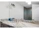 Bathroom featuring a granite vanity countertop, a large mirror and lighting fixture, and a glass enclosed shower at 3759 Beneva Oaks Blvd, Sarasota, FL 34238