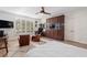 Bedroom with a mounted television, two armchairs, a ceiling fan, and a custom cabinet with a built-in aquarium at 3759 Beneva Oaks Blvd, Sarasota, FL 34238