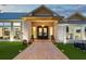 Elegant front entrance featuring double doors, brick walkway, and manicured landscaping at 3759 Beneva Oaks Blvd, Sarasota, FL 34238