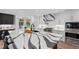 Kitchen island with white and grey marble and breakfast bar seating, plus modern appliances at 3759 Beneva Oaks Blvd, Sarasota, FL 34238