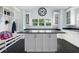 Mudroom with white cabinetry, a large island, coat racks, and a large window providing natural light at 3759 Beneva Oaks Blvd, Sarasota, FL 34238