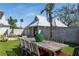 Outdoor dining area featuring a large wooden table, outdoor chess and a brick wall at 3759 Beneva Oaks Blvd, Sarasota, FL 34238