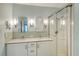 Clean bathroom with double vanity, large mirror and walk-in shower at 4147 Marseilles Ave # 3068, Sarasota, FL 34233