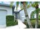 Front entry with gray walls, landscaping and walkway at 4147 Marseilles Ave # 3068, Sarasota, FL 34233