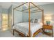 Spacious main bedroom with a four poster bed and ensuite bathroom access at 4147 Marseilles Ave # 3068, Sarasota, FL 34233