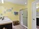 Double vanity bathroom with a walk-in shower and beach-themed decor at 431 Gris Sky Ln, Bradenton, FL 34212