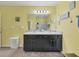 Double vanity bathroom with dark brown cabinets and a large mirror at 431 Gris Sky Ln, Bradenton, FL 34212