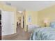 Bright bedroom with a leafy patterned bedspread and ensuite bathroom access at 431 Gris Sky Ln, Bradenton, FL 34212