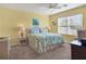 Spacious bedroom with ceiling fan, large window, and light green bedding at 431 Gris Sky Ln, Bradenton, FL 34212