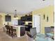 Open concept kitchen with island, dark cabinets, and stainless steel appliances at 431 Gris Sky Ln, Bradenton, FL 34212