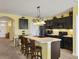 Modern kitchen with dark cabinetry and an island at 431 Gris Sky Ln, Bradenton, FL 34212