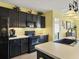 Bright kitchen with dark cabinets, stainless steel appliances, and a large island at 431 Gris Sky Ln, Bradenton, FL 34212