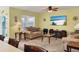 Living room with two sofas, coffee table, and large TV at 431 Gris Sky Ln, Bradenton, FL 34212