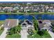 Aerial view of a neighborhood, showcasing home, lake, and solar panels on roof at 4617 Garden Arbor Way, Bradenton, FL 34203