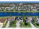 Aerial view of neighborhood homes along the water feature solar panels, and lush landscaping at 4617 Garden Arbor Way, Bradenton, FL 34203