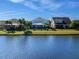 Water view of multiple homes with fenced backyards and well-manicured lawns at 4617 Garden Arbor Way, Bradenton, FL 34203