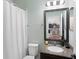 Bathroom featuring a granite countertop vanity, toilet, and shower with tile surround at 4617 Garden Arbor Way, Bradenton, FL 34203