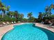 Community pool features shallow ends, brick patio, and many lounge chairs for residents at 4617 Garden Arbor Way, Bradenton, FL 34203