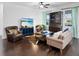 Living room featuring stylish seating, hardwood floors, and lake views from the windows at 4617 Garden Arbor Way, Bradenton, FL 34203