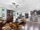 Open-concept living room featuring hardwood floors, ceiling fan, and access to the kitchen and dining area at 4617 Garden Arbor Way, Bradenton, FL 34203