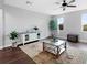 Bright, open living room with a decorative rug, plants, and natural light from the windows at 4617 Garden Arbor Way, Bradenton, FL 34203