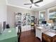 Home office with custom bookshelves, a ceiling fan, and a work space with two monitors at 4617 Garden Arbor Way, Bradenton, FL 34203