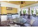 Covered outdoor kitchen and dining area with stainless steel grill, prep sink, and fan at 4617 Garden Arbor Way, Bradenton, FL 34203