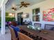 Covered patio featuring comfortable seating, a ceiling fan, and a view of the outdoor space at 4617 Garden Arbor Way, Bradenton, FL 34203