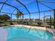 Beautiful pool with a screened enclosure, providing a serene outdoor oasis with picturesque lake and neighborhood views at 4617 Garden Arbor Way, Bradenton, FL 34203