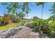 Stunning backyard features a wood deck with swing, perfect for relaxing by the water at 494 E Shade Dr, Venice, FL 34293