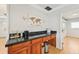 Wooden desk area with black countertop and wall-mounted lighting fixtures at 494 E Shade Dr, Venice, FL 34293