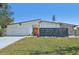 Charming single-story home features a modern design with a stone accent wall and a well-maintained lawn at 494 E Shade Dr, Venice, FL 34293