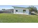 View of the home's exterior with a view of the screened-in pool at 494 E Shade Dr, Venice, FL 34293