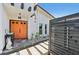 Inviting entrance with a vibrant orange double front door and modern architectural details at 494 E Shade Dr, Venice, FL 34293