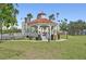 Picturesque white gazebo with orange tile roof set in a manicured green park in Venice, Florida at 494 E Shade Dr, Venice, FL 34293