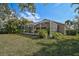 Screened in back porch offers views of palm trees and verdant landscaping at 4969 Creekside Trl, Sarasota, FL 34243