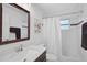 Well-maintained bathroom with a vanity, mirror, and shower featuring a curtain at 4969 Creekside Trl, Sarasota, FL 34243